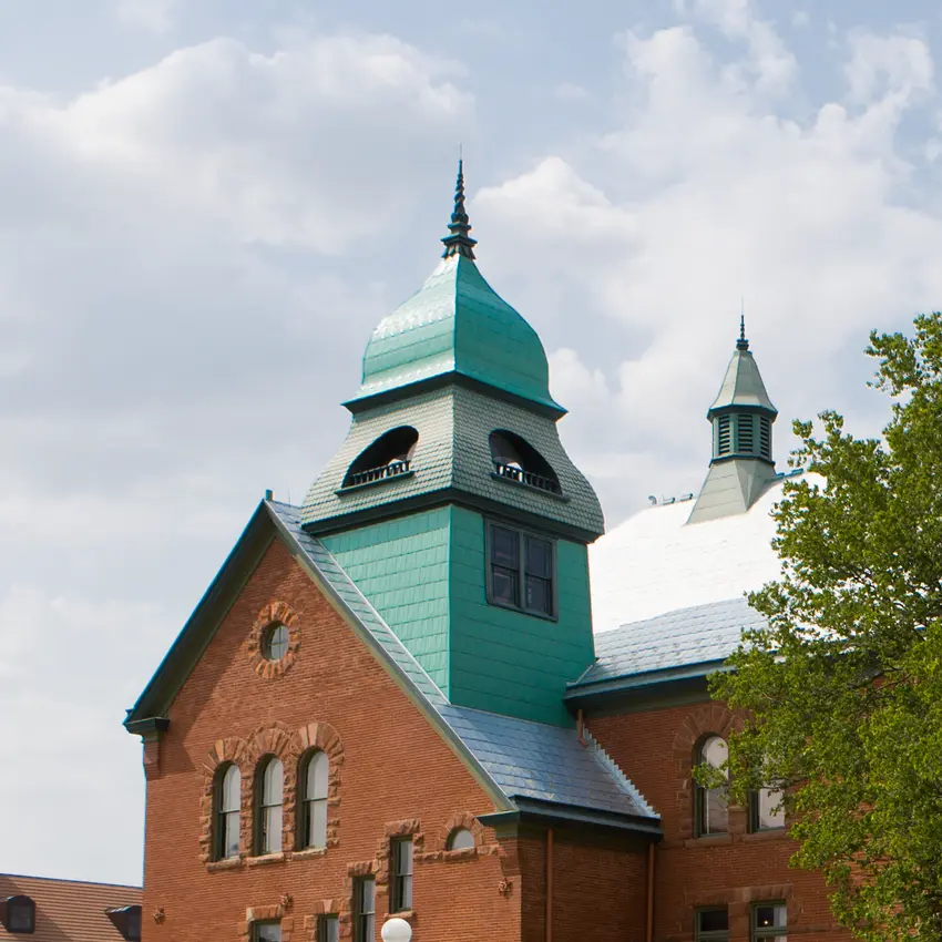 OSU's Old Central tower shines against a summer blue sky.