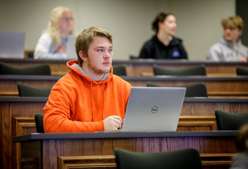 student listening to lecture in classroom