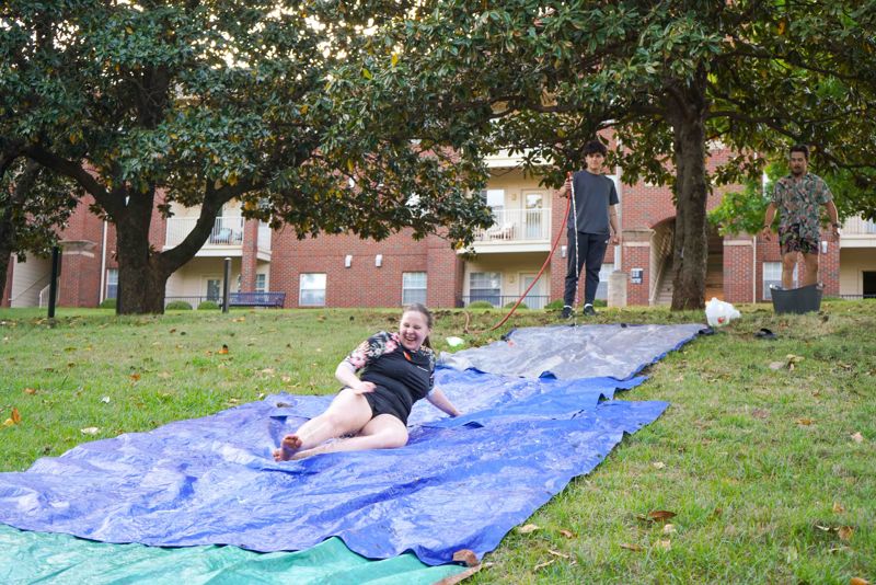 female student on water slide at Morrison Neighborhood