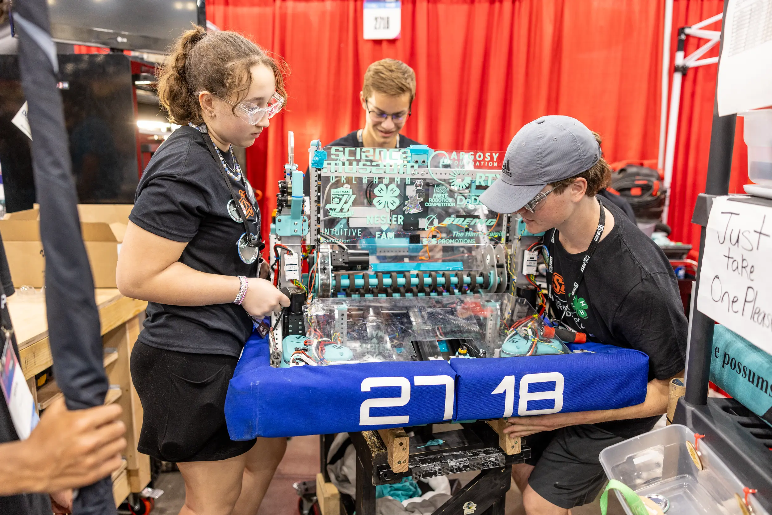 Middle school students work on robot at 4H STEM event.