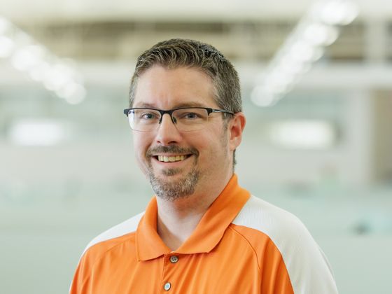 Man wearing an orange and white OSU collared shirt