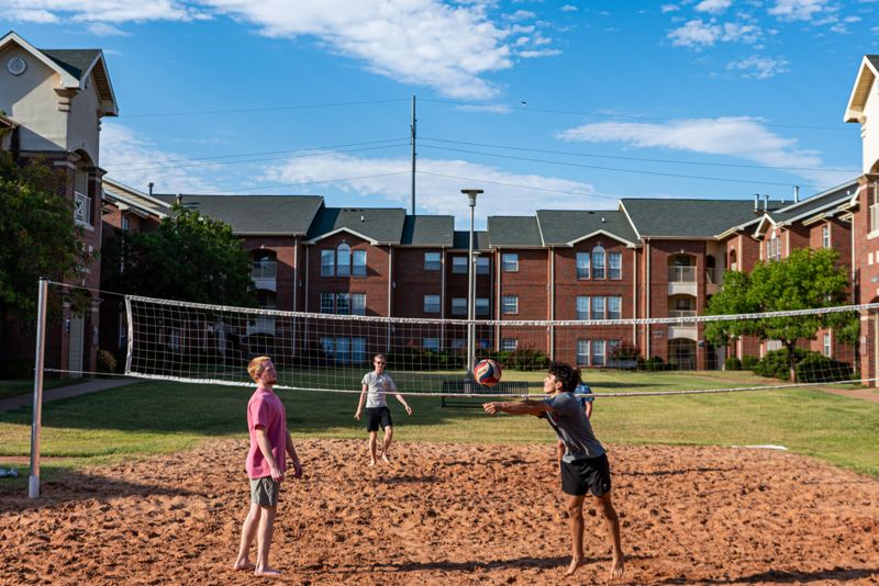 students laying volleyball