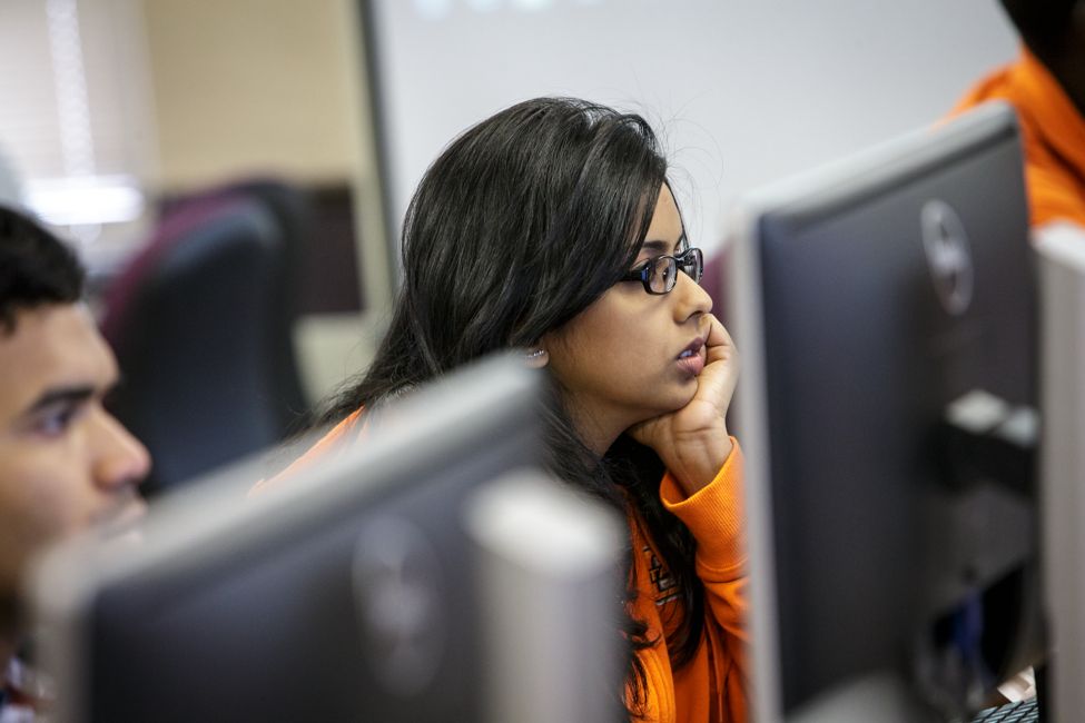 male and female students using computers