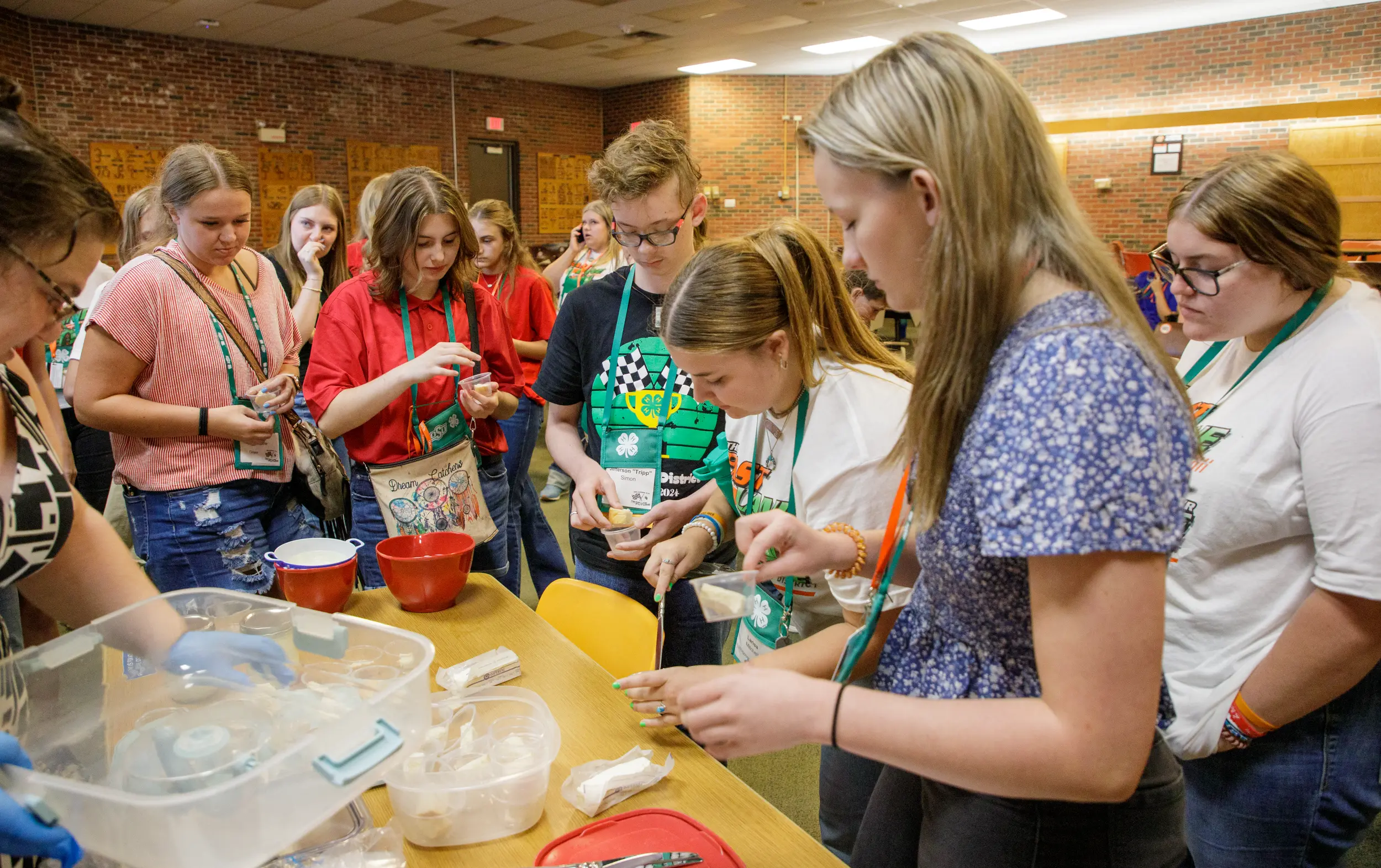 Young students gather around a table for cooking class.