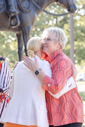 OSU President Kayse Shrum and Edna Mae Holden hug after the monument is unveiled.