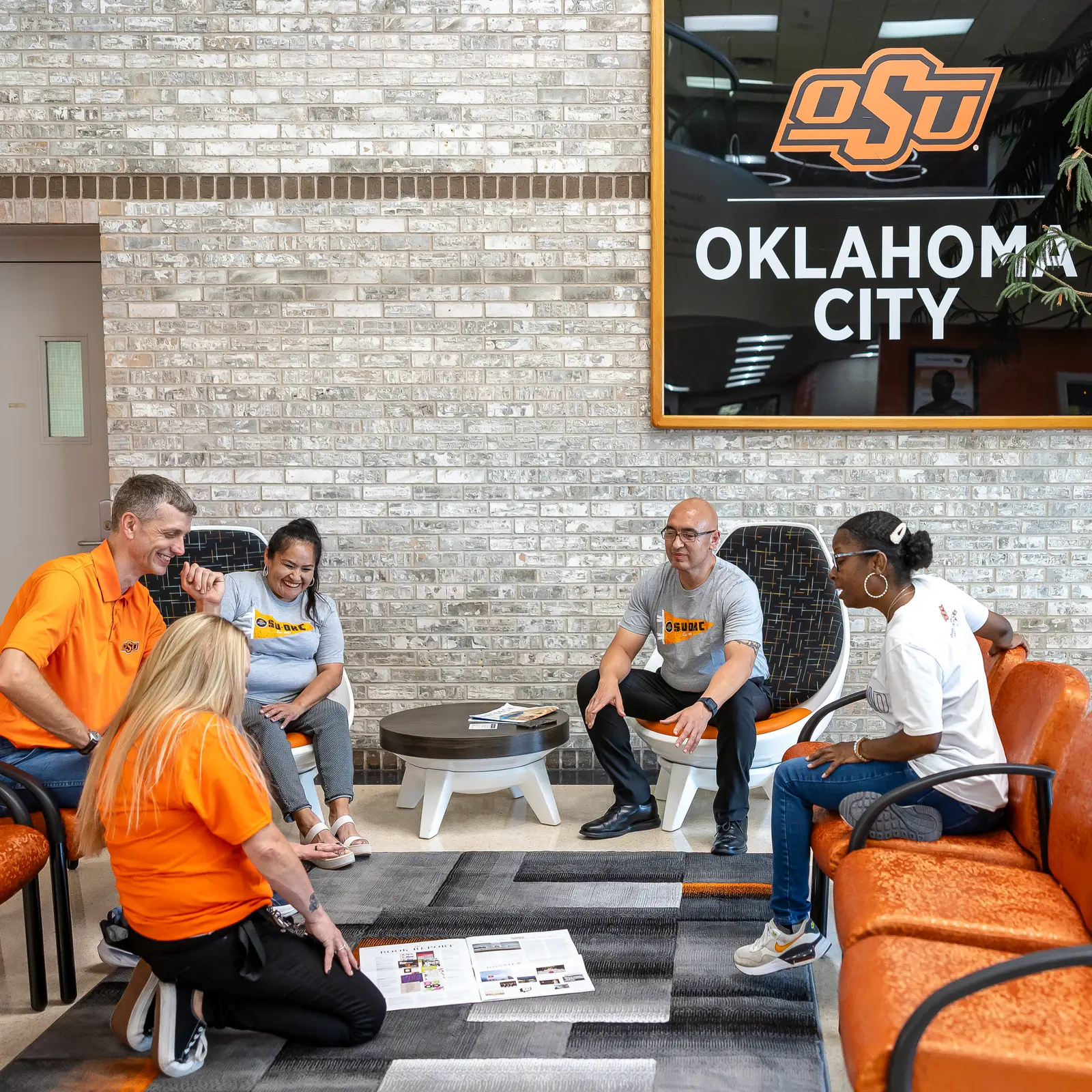 Adult students sitting and talking in OSU-OKC lounge.