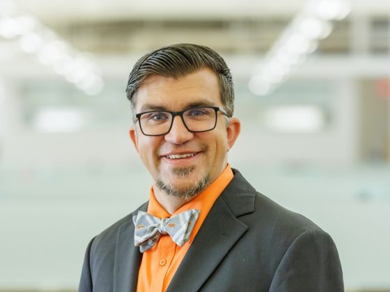 Man wearing a black suit with a bowtie