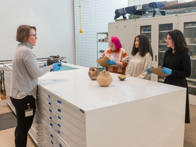 Students looking at objects in the vault. 